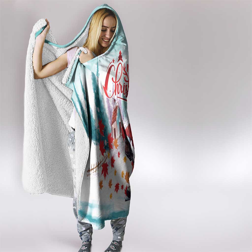 Mint hooded blanket with hood up, white sherpa trim, and red Santa hockey graphic