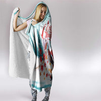 Mint hooded blanket with hood up, white sherpa trim, and red Santa hockey graphic