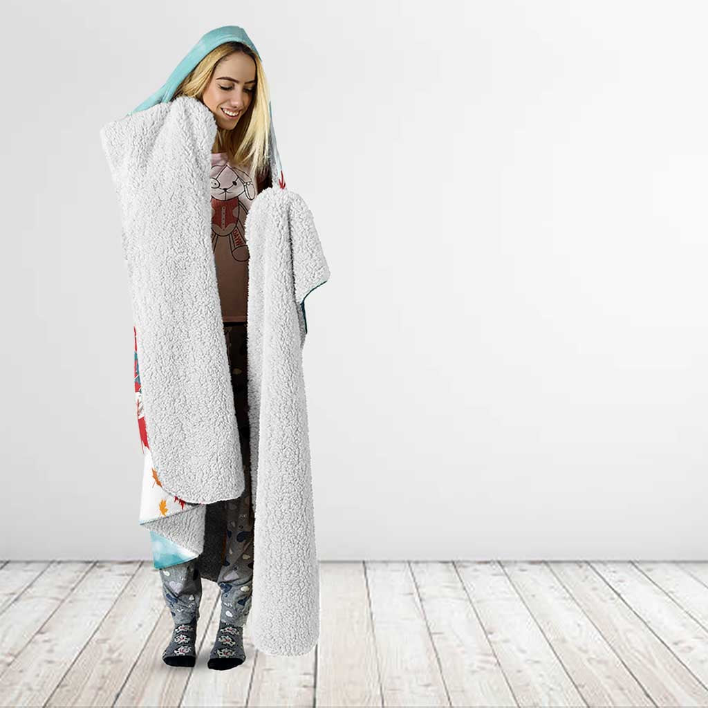 Mint hooded blanket with plush sherpa sleeves, hood, and Santa hockey print