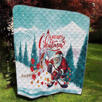 Mint and white quilt with Santa playing hockey and 'Merry Christmas' over diamond pattern