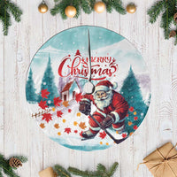 Mint round tree skirt with Santa playing hockey and “Merry Christmas” graphic center