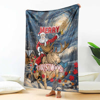 Holiday blanket featuring Santa on a moose, starry night sky and “Merry Christmoose” text