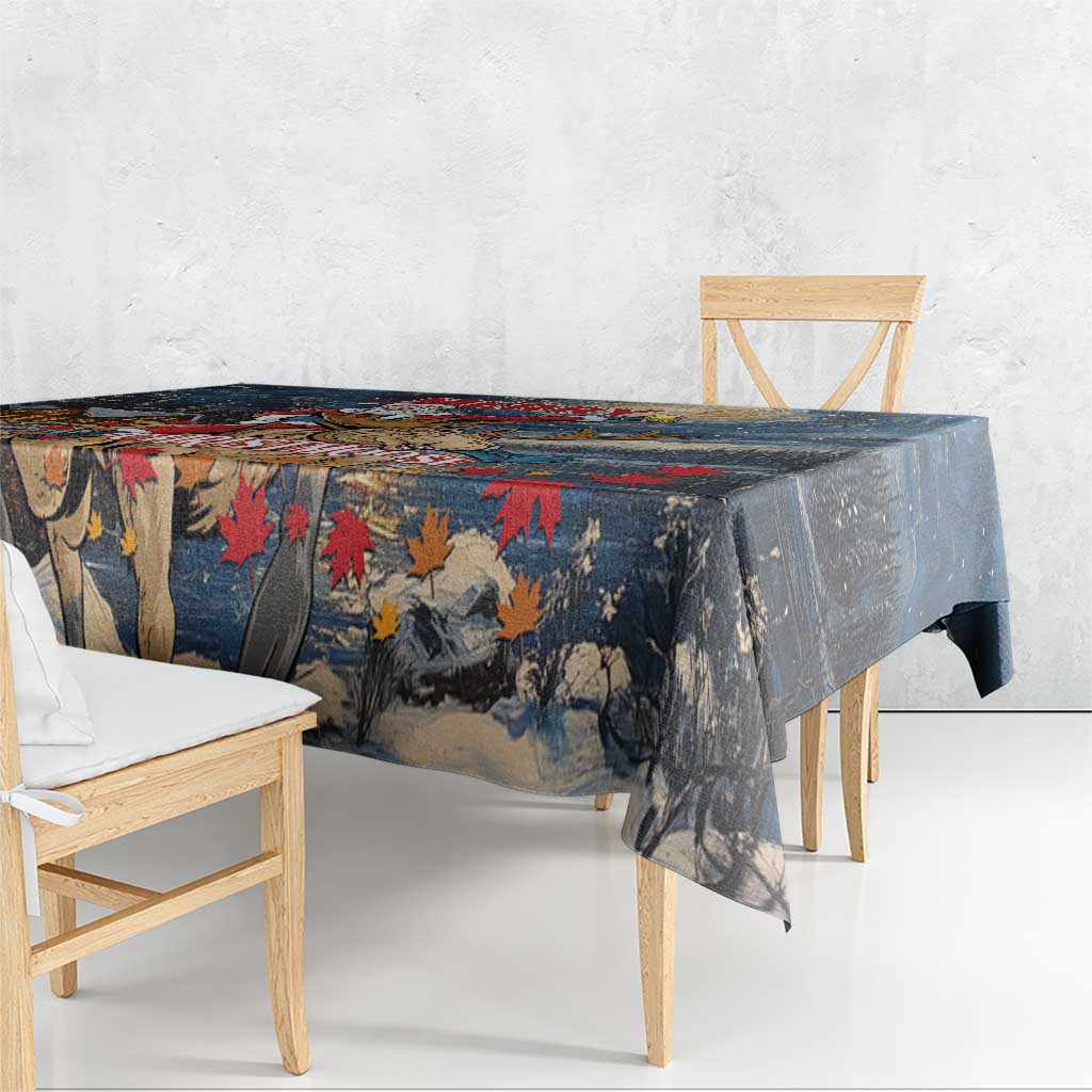 Blue tablecloth corner with red and orange tree/leaf motifs