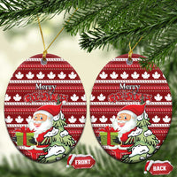Red ceramic oval Christmas ornament with hanging loop; Santa and Merry Christmas on maple leaf stripes.