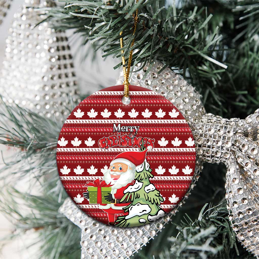 Red round ceramic Christmas ornament hanging on tree; Santa scene and Merry Christmas over maple leaf pattern.