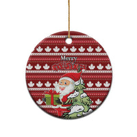Red round ceramic Christmas ornament with hanging loop; Santa and Merry Christmas on maple leaf stripes.
