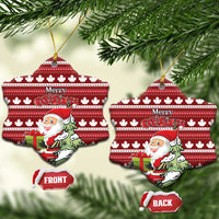 Red ceramic snowflake-shaped Christmas ornament with hanging loop; Santa and Merry Christmas on maple leaf pattern.