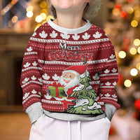Kids red ugly Christmas sweater with Santa holding gifts and green tree graphic