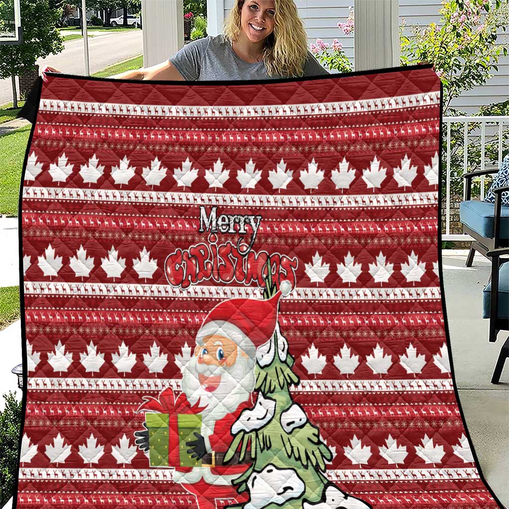 Red Christmas quilt with maple leaf pattern, Santa holding a gift and “Merry Christmas” text