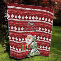 Red Christmas quilt with maple leaves, Santa in a hat, and “Merry Christmas” lettering