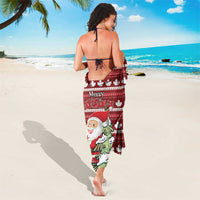 Red Christmas sarong featuring Santa and tree with scattered white maple leaves