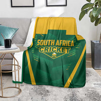 Green and yellow South Africa Cricket blanket on floor, centered logo with stripes