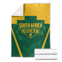 Folded green and yellow South Africa Cricket blanket with crest and striped pattern