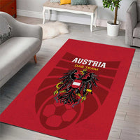 Red rectangular rug featuring Austria Das Team text and heraldic crest