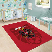 Red rectangular rug showing Austria Das Team text and team crest design