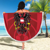 Red round football beach blanket with white fringe, Austria crest design