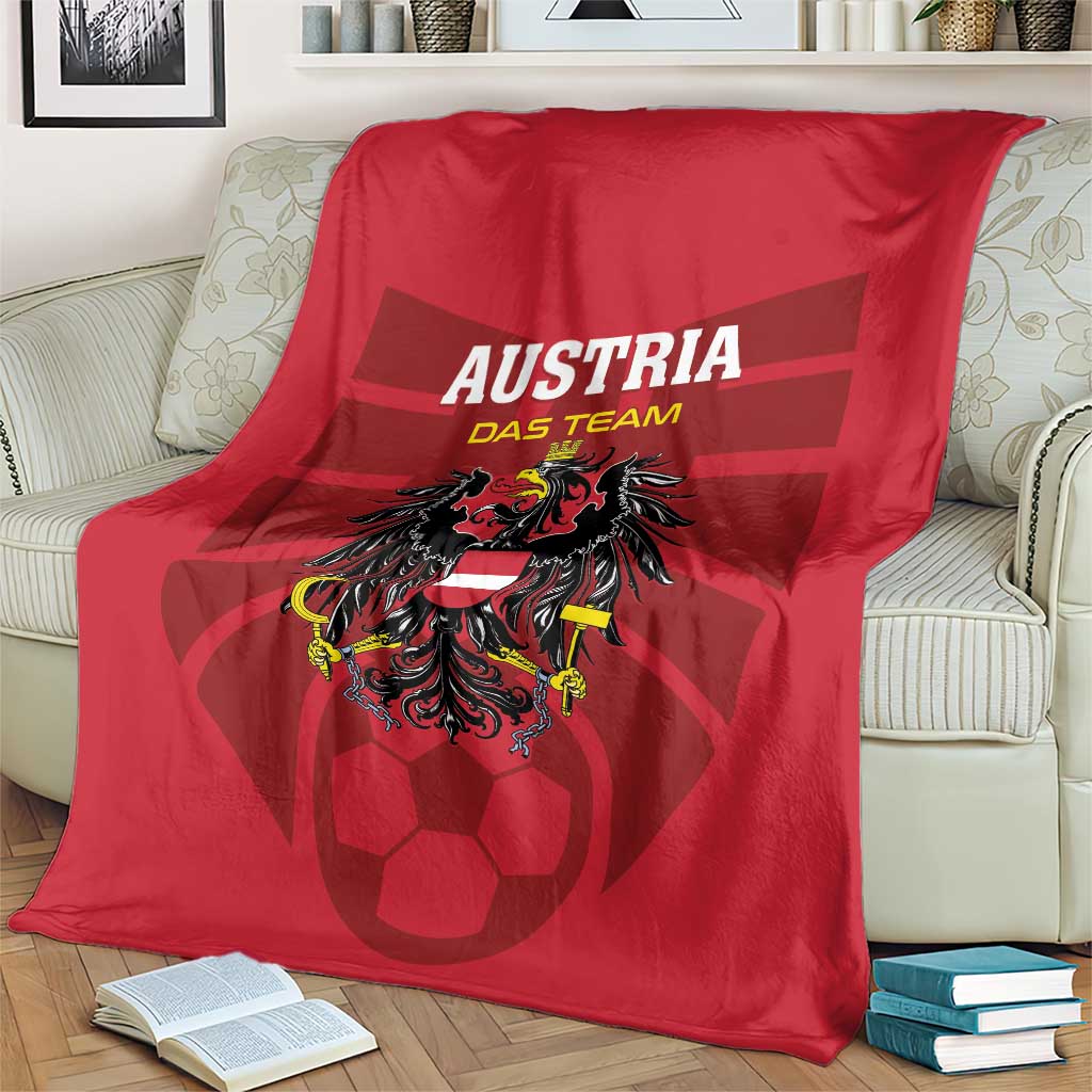 Red Austria football blanket with team crest and lettering, draped on armchair