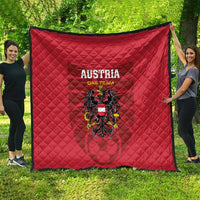 Red Austria team quilt blanket with center crest and 'AUSTRIA DAS TEAM' text