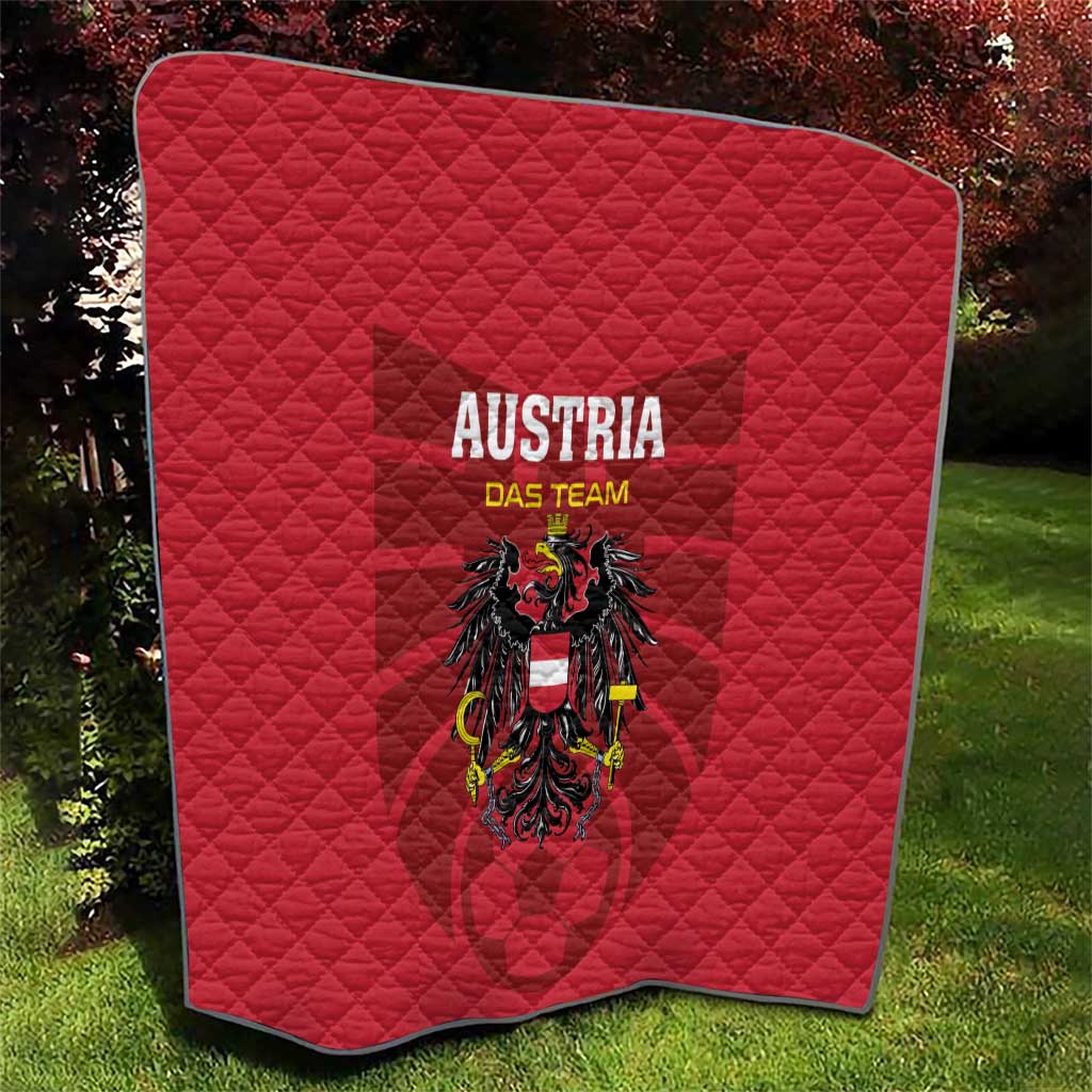 Red quilt blanket with diamond stitching, 'AUSTRIA DAS TEAM' and eagle crest