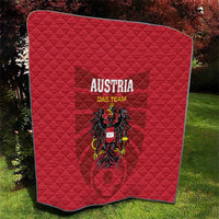 Red quilt blanket with diamond stitching, 'AUSTRIA DAS TEAM' and eagle crest