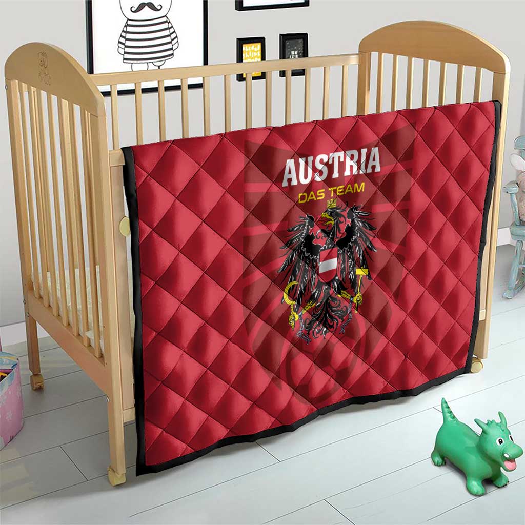 Red quilt blanket with 'AUSTRIA DAS TEAM' text and black eagle crest, quilted