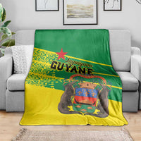 Yellow and green Guyane blanket draped over sofa with central animal portrait graphic