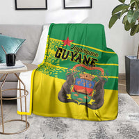 Yellow and green French Guiana blanket with Guyane logo and stylized elephant graphic
