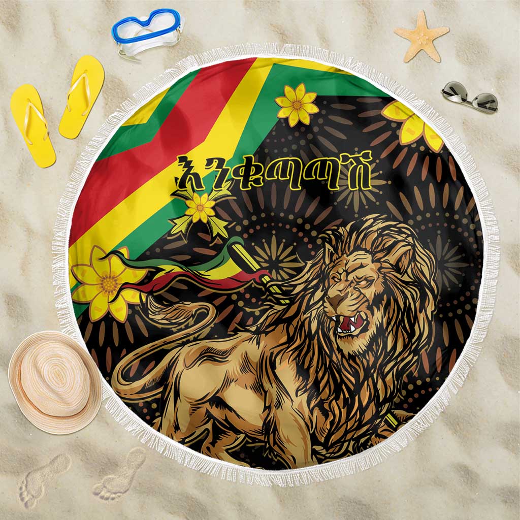 Round black beach blanket featuring roaring lion, flower accents, and white fringe trim