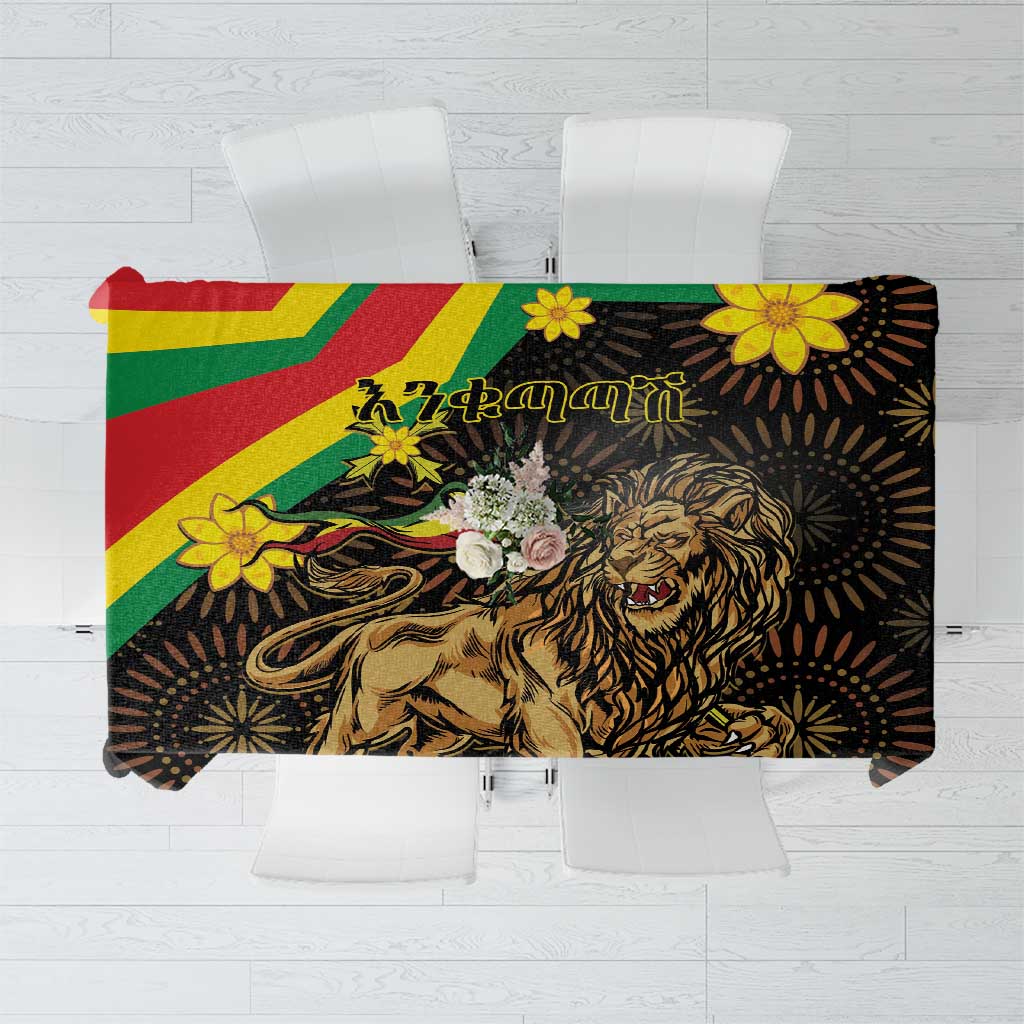 Black tablecloth centerpiece panel with roaring lion illustration and yellow flower details