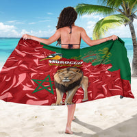 Printed Morocco sarong with lion and bird artwork on red-and-green flag pattern, draped.