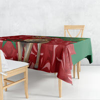 Red and green printed tablecloth draped over a dining table