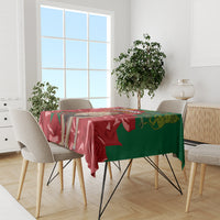 Red and green patterned tablecloth on a dining table with chairs