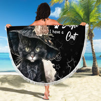 Black round beach blanket with cat illustration and paw icons, fringed edge held up