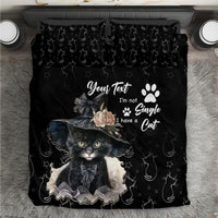 Black cat-themed bedding set with paw prints and large cat portrait design