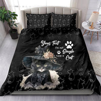 Black bedding set with cat portrait graphic, paw-print motif, and matching pattern
