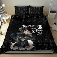 Black cat-themed bedding set with cat portrait graphic, paw prints, and star accents