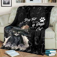 Black cat blanket with crescent-and-cat icons and portrait graphic, draped on couch