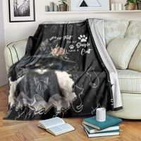 Black cat blanket spread on couch with floral roses and paw-print text graphic