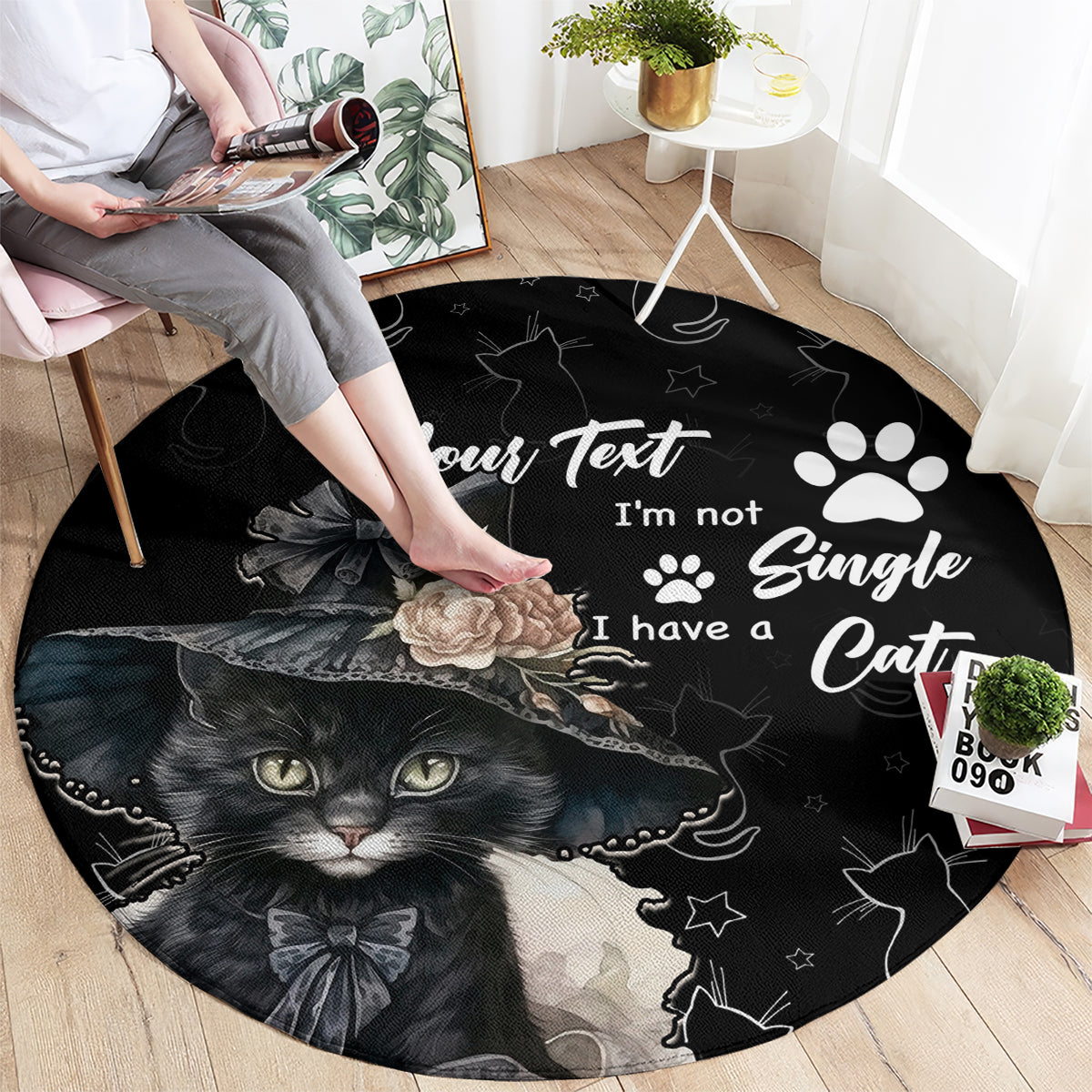 Black round cat area rug with text-style design, paw prints, and kitten face graphic