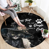 Black round cat area rug with text-style design, paw prints, and kitten face graphic