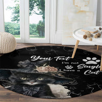 Black round cat carpet with cat face, star doodles, paw prints, and rose accents