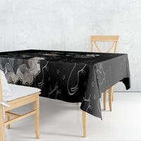 Black tablecloth over table with repeating cat and moon/star doodle pattern