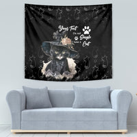 Black decorative tapestry showing an illustrated cat with a hat, flowers, and paw prints