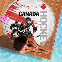 Round hockey beach blanket in red and white with players, maple leaves, and fringe