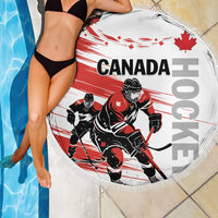 Round red and white hockey beach blanket with CANADA text, goalie players, and fringed border