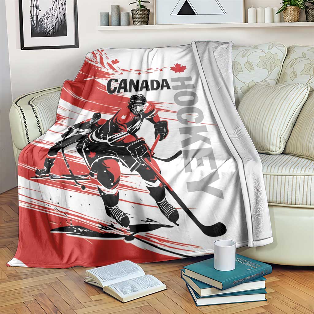Canada hockey blanket with red-and-white player graphic and maple leaf, folded over couch