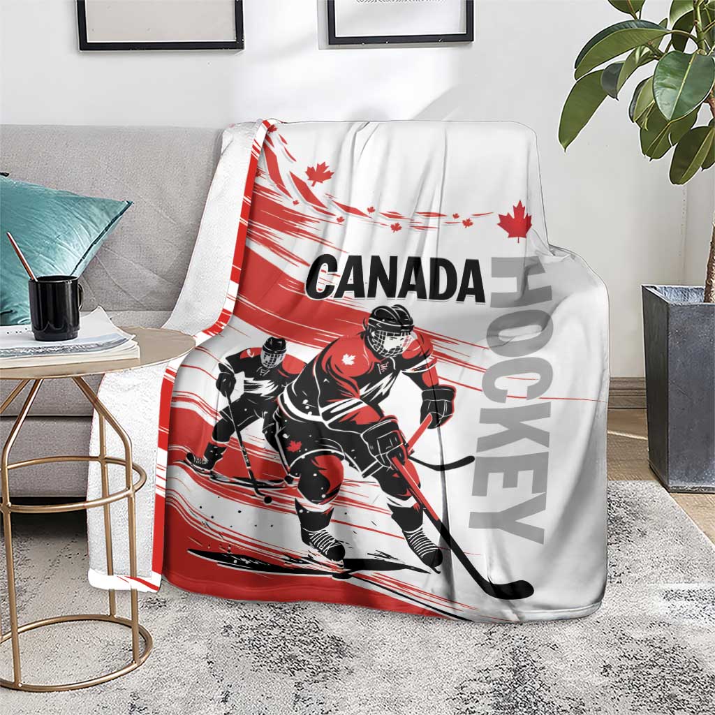 Canada hockey blanket on gray sofa with red-and-white hockey player print and Canada lettering