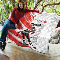 Red and white Canada hockey quilt draped over an outdoor seat with diamond quilting