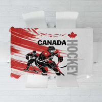 Red and white hockey-themed tablecloth with Canada design on a square table