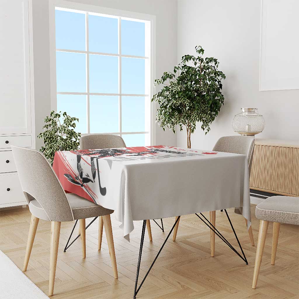 Red and white hockey-themed tablecloth draped over dining table with chairs
